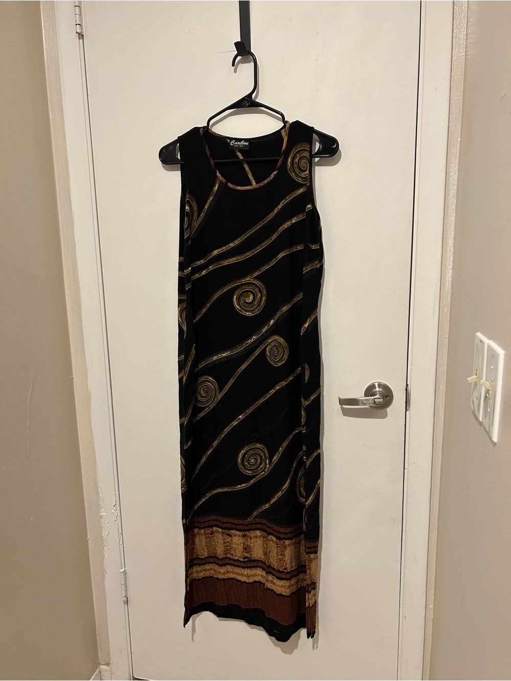 Caribou black maxi dress with gold swirls and brown stripes at the hem